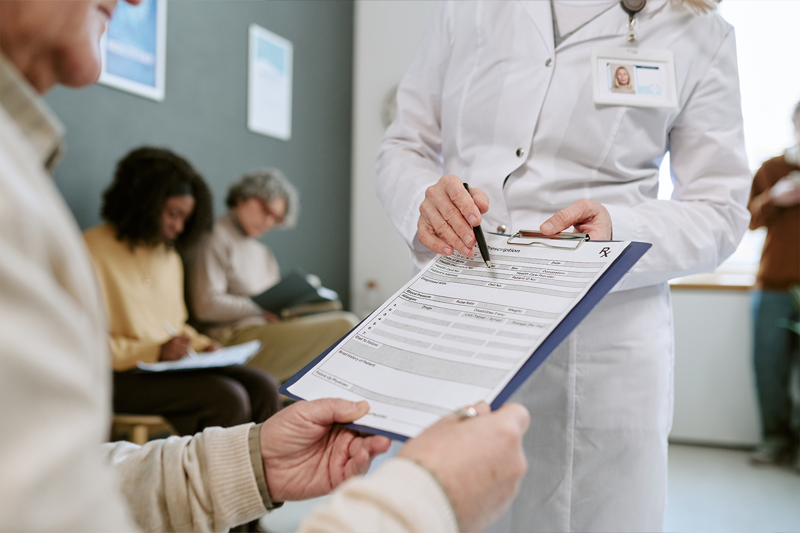 senior woman reviewing medical intake form in clin 2026 04 10 17 54 05 utc rev